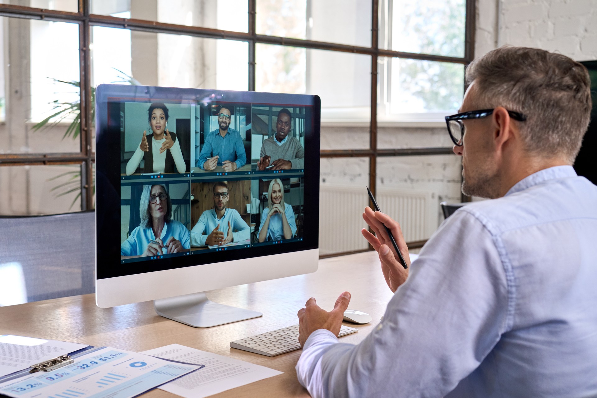 Corporate manager leading videoconference with team business people on computer.